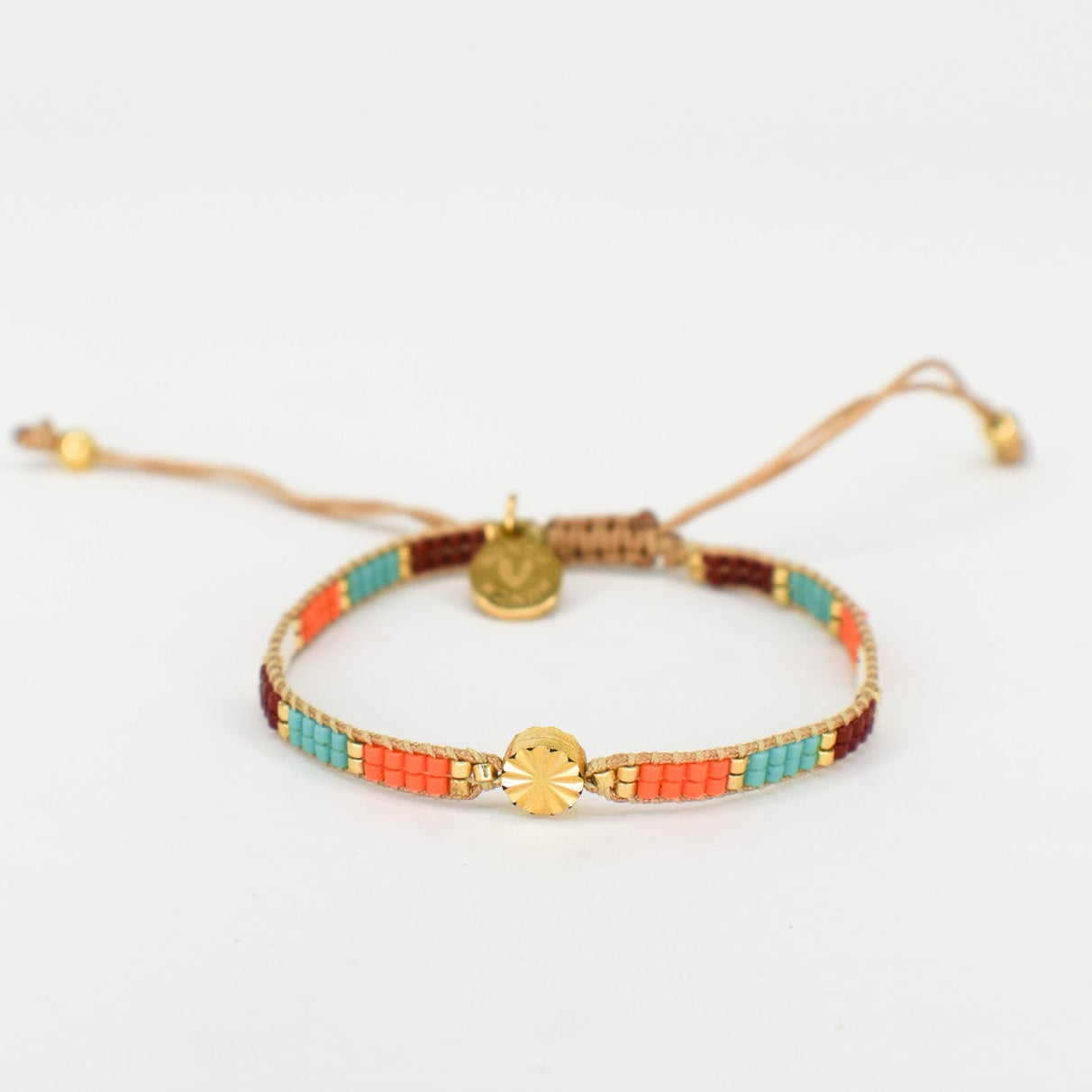 Bracelet with colorful beads and gold accents on a white background