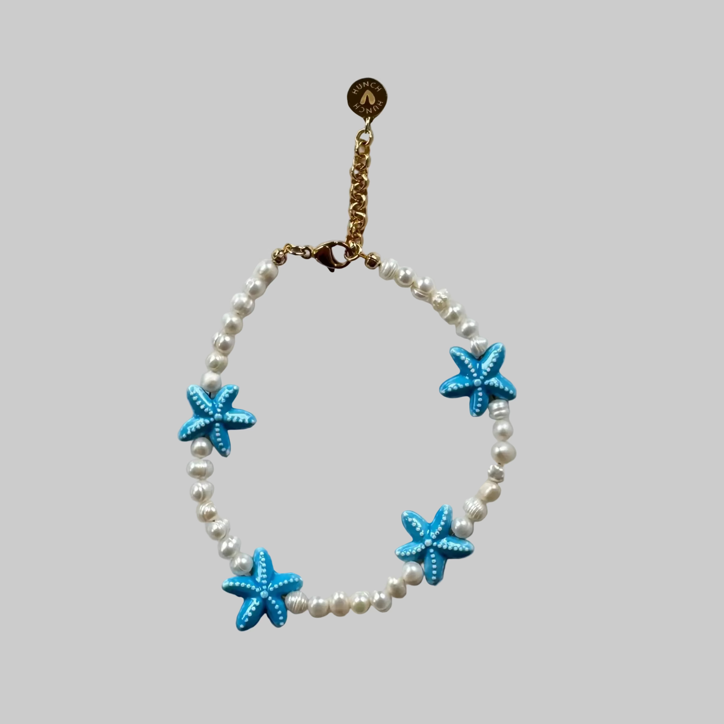 Bracelet with blue starfish charms and fresh water Pearls
