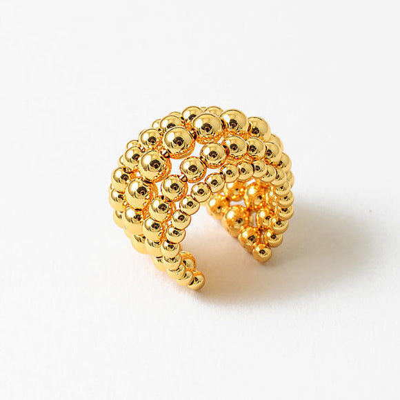 The Cora Ring features a bold beaded design crafted in 18k gold-filled with an open-back, adjustable fit. This statement ring wraps comfortably around the finger and adds instant texture and shine. Perfect worn solo or stacked with your favorites.