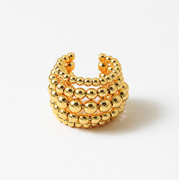 The Cora Ring features a bold beaded design crafted in 18k gold-filled with an open-back, adjustable fit. This statement ring wraps comfortably around the finger and adds instant texture and shine. Perfect worn solo or stacked with your favorites.