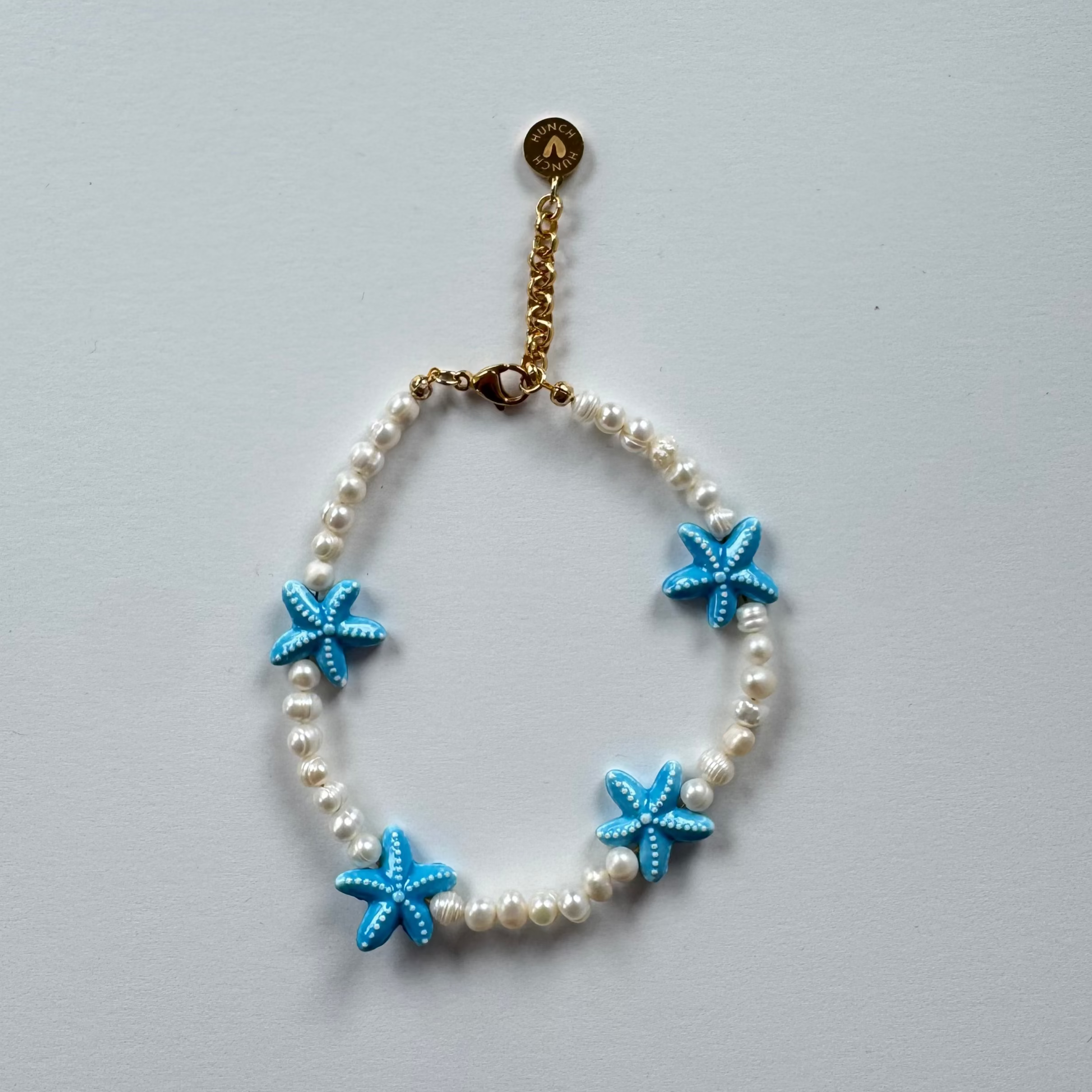 Bracelet with blue starfish charms and fresh water Pearls 