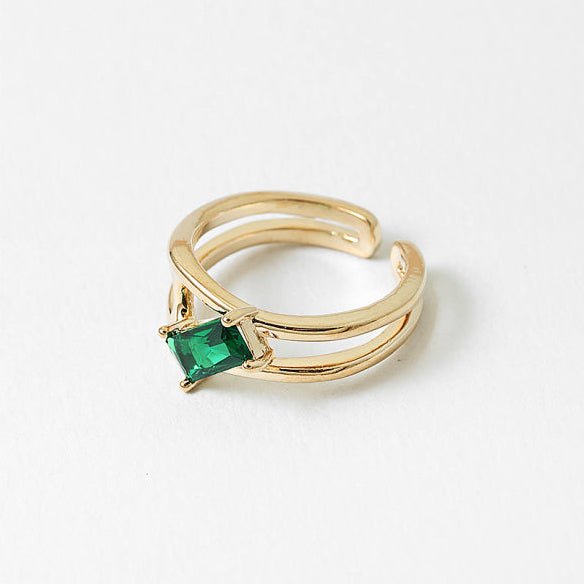 An adjustable open-back ring with a vibrant green cubic zirconia. Minimal, comfortable, and designed to shine every day.