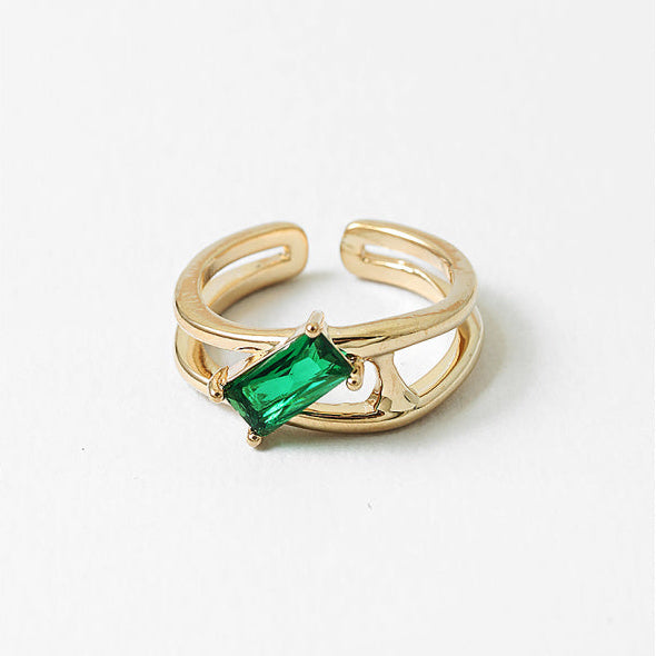 An adjustable open-back ring with a vibrant green cubic zirconia. Minimal, comfortable, and designed to shine every day.