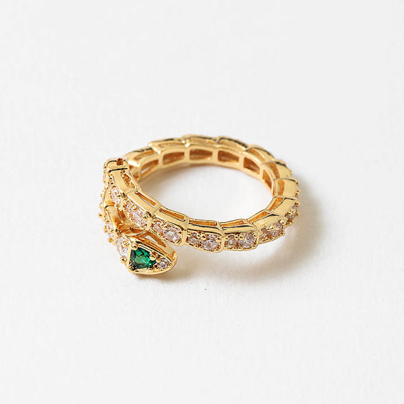 Gold ring with green gemstone on a white background